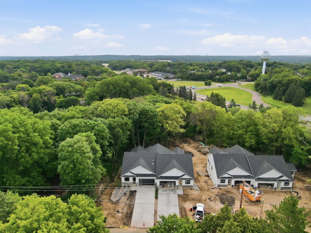 Aerial view of the Excelsior Woods twin homes and surrounding trees