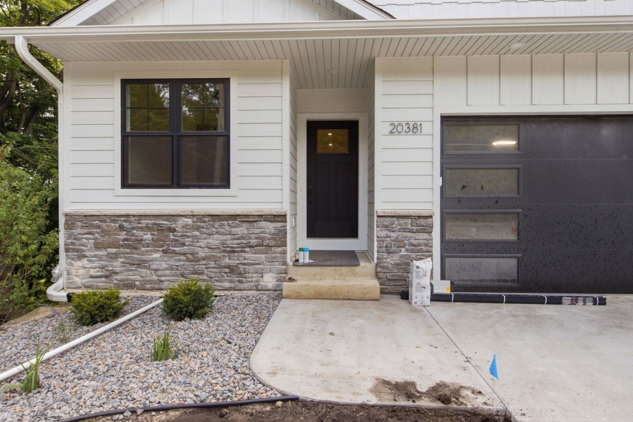 Entry and garage of 20381 Excelsior Boulevard, a completed twin home of the same design